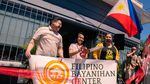 Celebrants cut a red ribbon at the grand opening of Portland's Filipino Bayanihan Center in June 2021. Three people are pictured in front of a small building holding a banner that reads "FILIPINO BAYANIHAN CENTER." Behind them hangs a Filipino flag. One woman holds large scissors which she's just used to cut a red ribbon across the front of the building's entrance.