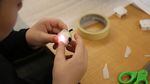 A Tumalo Community school student prepares a light he programmed to go into a student-designed product. 