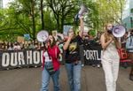 (Left to right) Maya Malka, 17, JJ Klein-Wolf, 15, and Dana Savage, 15, lead thousands of area youth climate activists and supporters on a march through downtown Portland, May 20, 2022, as part of a youth-led climate mobilization demanding city leaders take meaningful action on climate change.