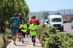 Runners carry carved wooden salmon as they run down South 6th Street in Klamath Falls, Oregon on their way to the Klamath River's headwaters in Southern Oregon on May 28, 2017