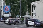 Portland police officers closed off the area around a Motel 6 on Holladay Street in Northeast Portland on Thursday, June 24, 2021.