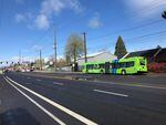 A new TriMet FX bus is parked along the Division Street route between Downtown Portland and Gresham.