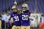 Washington's Asa Turner (20) celebrates with Kamren Fabiculanan (31) after Turner intercepted a pass in the final minute of an NCAA college football game against Oregon State in Seattle, in this Saturday, Nov. 14, 2020, file photo.