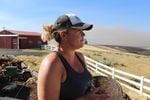 Cynthia Kortge watches the billowing wildfire smoke from her back porch in Wasco County. Her husband Jeff farms the thousands of acres of wheat on their property, most of it was destroyed in the blaze.