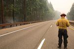 A firefighter stands on Interstate 84, which has been closed because of the Eagle Creek Fire.
