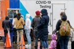 A line of people wait for COVID-19 tests at the Oregon Convention Center testing site operated by Curative, Jan. 6, 2022. 