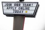 FILE: A sign seeking workers is displayed at a fast food restaurant in Portland, Ore., last December. The state says employment in Oregon has gotten back to similar numbers as before the pandemic.