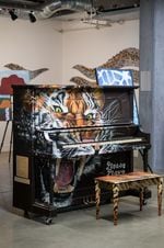 A tiger-themed piano made by artist Caleb Jay for Piano. Push. Play.