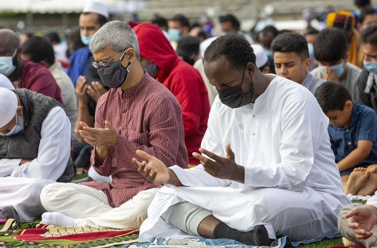 Portland-area Muslims came together on Tuesday, July 20, 2021, to celebrate Eid Al-Adha, at Hillsboro Stadium in Hillsboro. Worshippers raise their hands to pray at the end of the sermon.