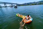 Stella Hartfield, 17, left, and her boyfriend Orion Crofut, 19, both of Lake Oswego, took to the Willamette River in Portland to cool off, June 28, 2021. 