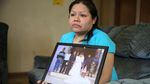 Rosalina Guzman holds a photo of her and her husband, Roman, from their wedding day.