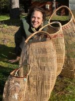 Sophie Weinstein's mother, Lisa Hillman, is a master basket weaver. She poses with some of the variously sized hazel baskets she has created.