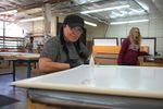 Melanie Baca helps produce window inserts at the Portland company Indow on March 16, 2020. Most employees started working from home during the coronavirus pandemic, but the factory workers can't do that.
