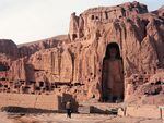 A man walks near a colossal Buddha statue in Bamiyan, Afghanistan, in 1997. The Taliban destroyed the famous Buddhas of Bamiyan in March 2001.