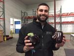 Imperfect Produce CEO Ben Simon shows off two 'ugly' eggplants in his new company warehouse in Clackamas.