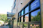 Boise-Eliot-Humboldt School is reflected in the windows of a yoga studio and bakery in North Portland.