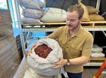 Seth O’Malley shows off a bag of dried rose petals used by Wilderton at their distillery and tasting room in Hood River, Ore. on August 2, 2023. As the founding distiller, O’Malley says he sources ingredients for the nonalcoholic botanical spirit from six continents.