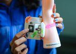 13-year-old Anushka Naiknaware holds a model of her award-winning smart bandage
