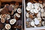 An example of the laser-engraved wooden tokens Toasted Maple makes for clients like Lululemon from its workspace in The Dalles, Ore., July 18, 2019. Owner Lindsey Brady is paying for software to stay compliant on other states' sales tax rules.