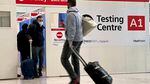Passengers get a COVID-19 test at Heathrow Airport in London.