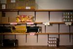 Emptied shelves of the stock room are seen after a food bank distribution event.