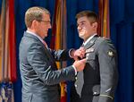 Defense Secretary Ash Carter, left, awards Oregon National Guardsman Alek Skarlatos with the Soldier's Medal during a ceremony at the Pentagon.