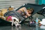 Christy Wilding of Portland stayed overnight with her two dogs at a cooling center at the Oregon Convention Center  in Portland, June 28, 2021. The cooling center provided water, snacks, meals, blankets, and cots or mats for sleeping.