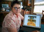 Susan Burdick shows a picture of what her tap water looked like after she paid to build a new well at her home in Deschutes County, Oregon in August 2020.  Months later, she paid to drill deeper in order to improve the water quality. July 1, 2022.