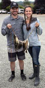 Kyle O’Hara and Michaela Campbell show off their catch: 34 voracious little bass.