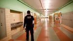 Officer Carlos Ibarra, a school resource officer, walks through the halls of Madison High School in Northeast Portland. 