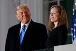 In this Monday, Oct. 26, 2020 file photo, President Donald Trump and Amy Coney Barrett stand on the Blue Room Balcony after Supreme Court Justice Clarence Thomas administered the Constitutional Oath to her on the South Lawn of the White House in Washington. President Donald Trump’s deep imprint on the federal courts is a rare point of agreement about the president across the political spectrum. With a major assist from Senate Majority Leader Mitch McConnell, Trump and his White House staff relentlessly, almost robotically, filled nearly every opening in the federal judiciary, undeterred by Democratic criticism. (AP Photo/Patrick Semansky, File)