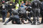 Portland police arrest a protester who skated past a police barricade during an afternoon of protests in downtown Portland on Sunday, June 4, 2017. 