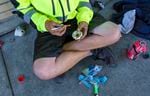 A 23-year-old man sits on the sidewalk in downtown Portland, preparing what he says is heroin, June 25, 2021. 
