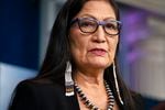 Interior Secretary Deb Haaland, wearing glasses, earrings and a beaded necklace, speaks during a news briefing at the White House in Washington.