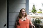 Mia Storm, 32, stands on her balcony as she recounts her childhood in the foster care system. Storm suffered physical and sexual abuse while in foster care from 1988 until 2002, when she turned 18 and was emancipated.