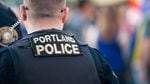 A Portland police officer photographed from behind.
