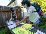 Vivien Lyon, left, and Natalie Hewitt, both of Portland, look over materials after they attended a signature training meeting for the effort to recall Portland Mayor Ted Wheeler, July 8, 2021 in Portland. 