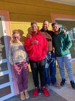 Annie Moss, left, on the porch of the Albina neighborhood home Moss sold to Randal Wyatt, (second from right) and his family in December 2020. Moss purchased the home in 2013, and sold it in 2020 to Wyatt, for what was left on the mortgage — well below the estimated fair market value of the home. 
