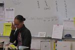 Rosa Parks teacher Nicole Holden reads in front of her classroom's whiteboard.
