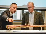Special Agent Jake Archer of the FBI Art Crime Team (left) and William Perthes of the Barnes Foundation examine the rifle during its repatriation ceremony.