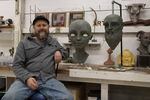 Sculptor Scott Foster sits next to a bust of a fawn made out of clay on Nov. 11, 2021. Foster’s Gaston, Oregon, studio doubles as a museum of sorts for his past projects which range from the bright and elaborate, to wondrous and weird.