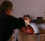 Artist Robert Anders pours liquid wax onto a clay form to create a wax positive. 