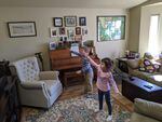 Reed, 6, with brother Adam, 8, dance to pass the time in Bend while they are staying at home during the coronavirus pandemic. 