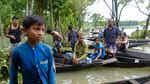 Flood affected people wait to receive relief material in Sylhet, Bangladesh, Wednesday, June 22, 2022.