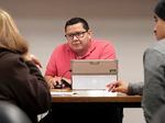 A health navigator helps people enroll in Obamacare plans in Dallas in 2017.  That year, federal funding for navigators was higher than it was under the Trump administration.  A record number of people signed up for plans.