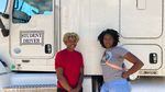 Amalya Livingston, right, poses in front of a truck at DSC Training Academy on June 29, with another student.  Livingston says she faces sexism on the road, but that doesn't deter her from driving.