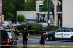 Portland police investigate the scene at a Motel 6 where earlier an officer shot and killed a man on June 24, 2021 in Portland, Oregon.