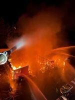 Firefighters attack a fire Wednesday morning, June 7, 2023, at an industrial complex in Salmon Creek in Vancouver, Washington. At least seven buildings were destroyed but no injuries were reported.