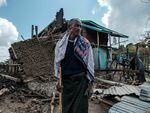 A man stands in front of his destroyed house in the village of Bisober in Ethiopia's Tigray region, on Dec. 9, 2020.
