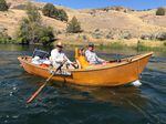 In performing his weekly river trip to maintain outhouses on the Deschutes River, Jerry Christensen loves to invite passengers to join him in his hand-built wooden drift boat. 